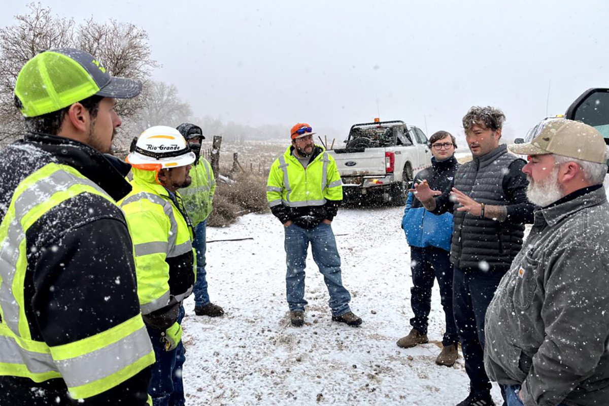 Stefan Soloviev, second from right, talks to workers atop La Veta Pass on Tuesday — the highest st